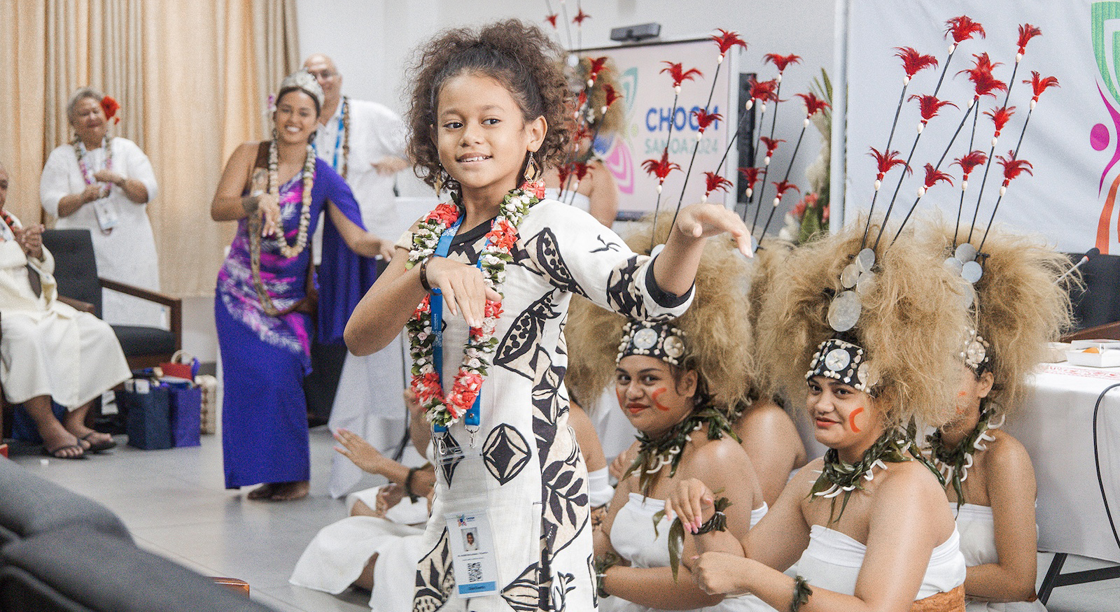 a young girl dances at the NCDs and mental health CHOGM event
