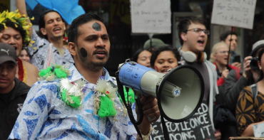 A young activist with a megaphone at a climate protest