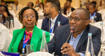 A man speaks into a microphone at an event