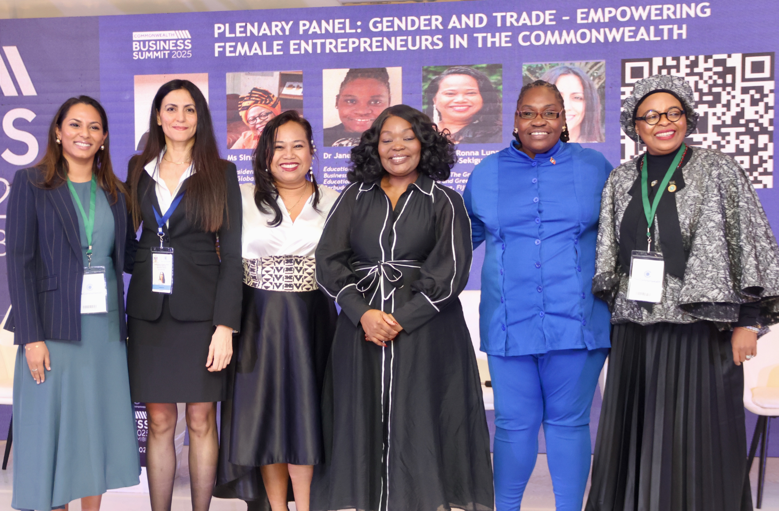 Six women sitting on a stage