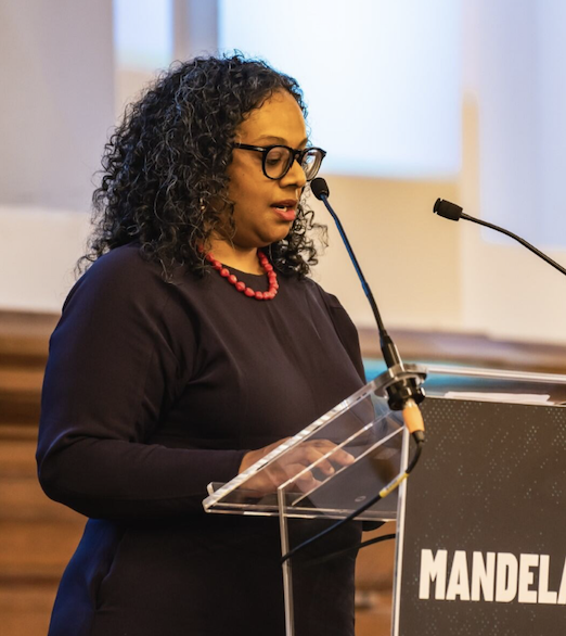 Thanisa  standing at a podium